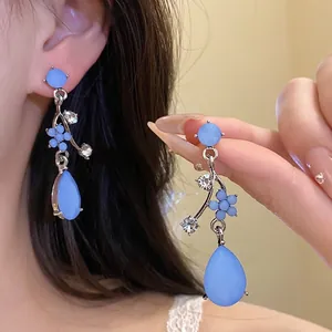 Elegant light blue resin flower teardrop earrings with sparkling rhinestones detail