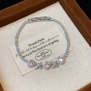 Elegant silver-toned flower bracelet with pink zircons and diamond-shaped accents.
