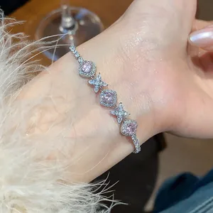 Detailed view of a French style silver flower bracelet with sparkling pink zircon stones
