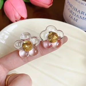 Minimalist resin flower stud earrings with yellow gemstone centers and silver pins