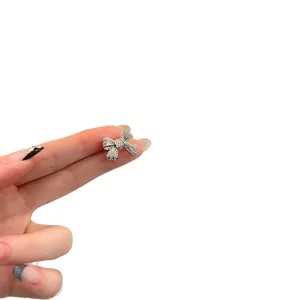 Sparkling silver bow-shaped ear clip with cubic zirconia detail for women