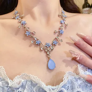 Elegant light blue flower necklace featuring a frosted teardrop resin pendant design