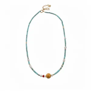 Vintage style turquoise beaded necklace with white pearls and yellow focal bead