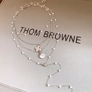 Elegant multi-layered pearl necklace with shell and flower pendants for women style