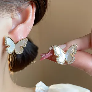 Close-up detail of exquisite 14k gold plated butterfly earring with sparkling zircons.