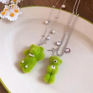 Cute plush green teddy bear necklace with pearl accents and sparkling heart zircon pendant