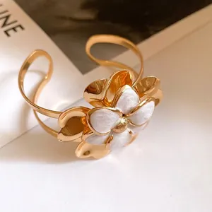 Vintage gold-plated cuff bracelet with double-layered white enamel flower design