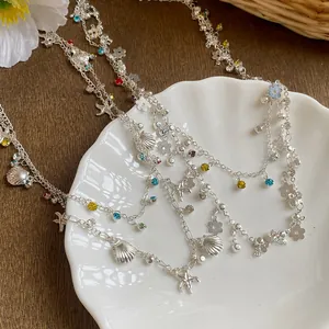 Detail of silver double-layer shell and starfish necklace with colorful rhinestones