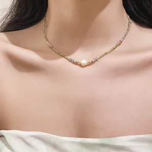 Elegant vintage stone beaded necklace with a central pearl detail on the collarbone
