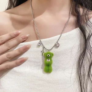 Detailed view of a green plush bear necklace with sparkling zircon charms.