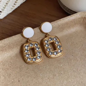 Close-up of vintage French style gold square earrings with sparkling rhinestones