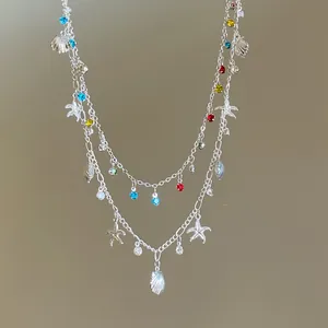Close-up view of a double-layered necklace featuring colorful rhinestones and sea charms.