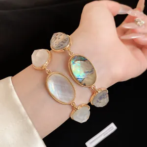 Close-up detail of a French retro resin oval faceted bracelet in a luxury gold finish