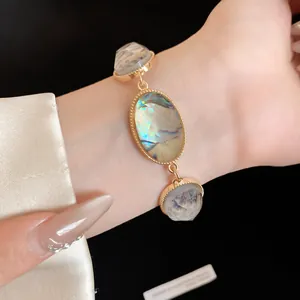 Detail view of a vintage faceted resin oval bracelet with elegant gold-tone chain