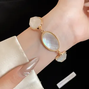 Detailed view of an elegant French vintage resin faceted oval bracelet on a model's wrist