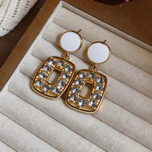 Elegant French vintage gold-toned earrings with sparkling crystals in a jewelry box
