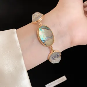 Close-up of a French vintage resin oval bracelet with gold-tone chain and iridescent finish