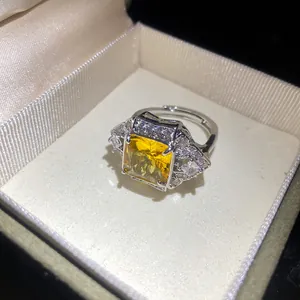 Macro view showing a square yellow zircon ring detail inside an elegant jewelry box