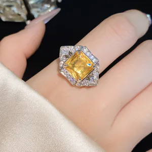 Detailed shot of an elegant silver ring with a square yellow zircon and pavé setting