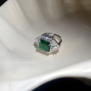 Macro view of a square emerald green zircon ring with sparkling accent stones