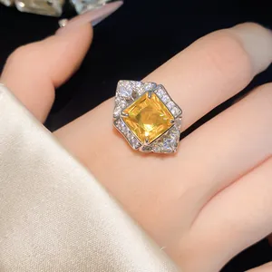 Detailed macro view of a luxury square yellow zircon ring with brilliant halo sparkles