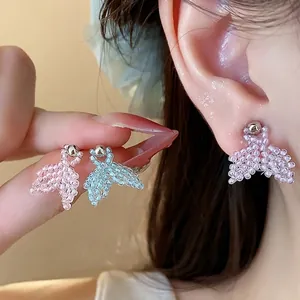 Handmade seed bead fishtail stud earrings with silver needles for a minimalist look