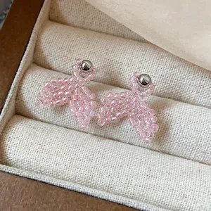 Minimalist pink beaded fishtail stud earrings with silver ball posts in jewelry box