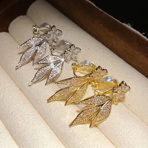 Elegant 14k gold plated flower and leaf zircon ear clips presented in a jewelry box