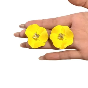 Vibrant yellow matte flower stud earrings featuring a central square yellow gemstone