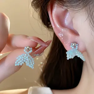 Elegant blue beaded fishtail earrings with silver needles shown in a close-up detail shot
