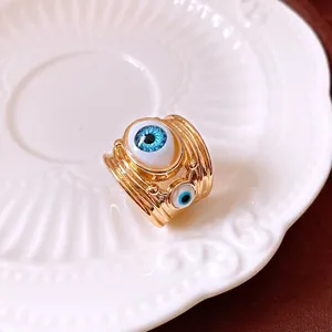 Fashionable gold plated open ring featuring a large blue resin evil eye design for women