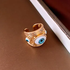 Luxury gold open ring featuring unique resin evil eye design for women's fashion.