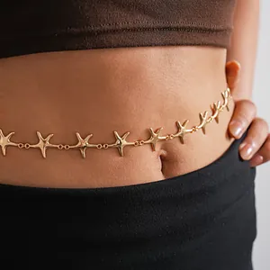 Detailed view of a minimalist gold-toned metallic starfish waist chain jewelry on skin.