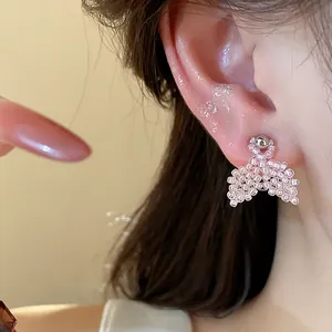 Detailed view of handmade pink beaded fishtail stud earrings with silver needles