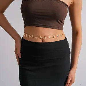 Detailed shot of a gold starfish waist chain on model, minimalist bohemian jewelry