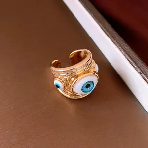 Detailed macro view of the gold-plated Evil Eye resin ring with blue iris accents.