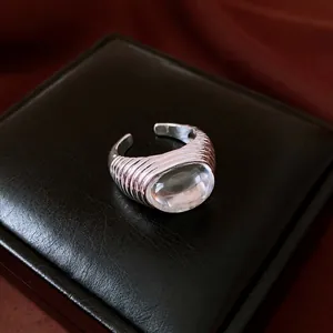 Retro minimalist silver open ring featuring a clear oval resin stone on a ribbed band