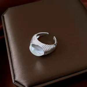 Macro view of vintage silver-tone open ring featuring a white resin dome detail