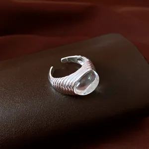 Macro shot of a vintage silver-colored geometric open ring with clear oval resin centerpiece