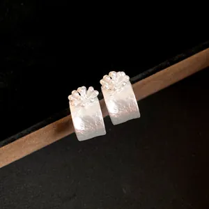 Elegant silver flower C-shaped stud earrings with premium matte finish for a luxury look
