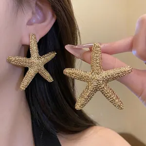 Large textured gold starfish stud earrings for women with minimalist beach style