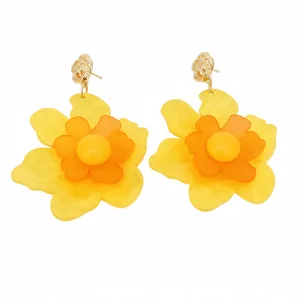 Vibrant yellow and orange resin flower earrings with layered petals and silver needle studs