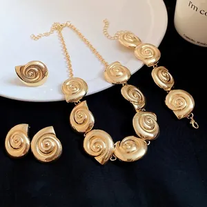 Vintage gold-toned spiral shell jewelry set including necklace, bracelet, earrings and ring.