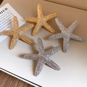 Detailed view of textured metallic starfish stud earrings in gold and silver finishes