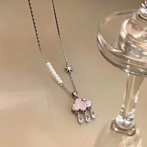 Close-up view of elegant cloud pendant necklace featuring glass raindrops and pearl details