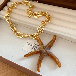 Retro acrylic starfish pendant necklace with chunky gold chain in jewelry box