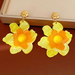 Detailed view of vibrant yellow resin flower earrings with elegant gold-tone rose studs