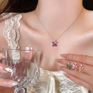 Detailed macro view of elegant zircon flower pendant necklaces in multiple colors for women.