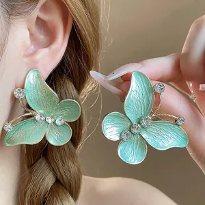 Elegant green enamel butterfly stud earrings with sparkling zircons and gold-plated finish