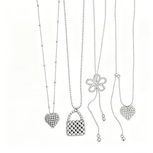 Detailed view of silver zircon necklaces featuring hollow flower and heart pendants.